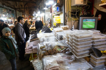 A Tabriz, les commerçants regardent le match Iran-Angleterre au travail  