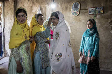 دخترها در حال آراستنِ مِینا و لَچَک (روسری محلی) خودهستند تا برای جشن عروسی آماده شوند.