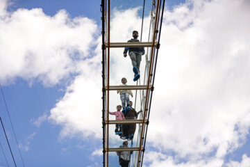Tourists visiting Iran's largest glass suspension bridge