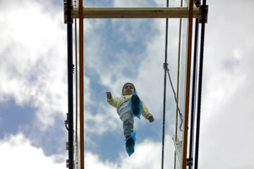 Tourists visiting Iran's largest glass suspension bridge