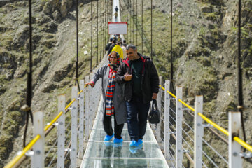 Tourists visiting Iran's largest glass suspension bridge