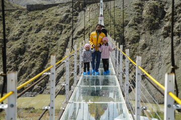 Tourists visiting Iran's largest glass suspension bridge