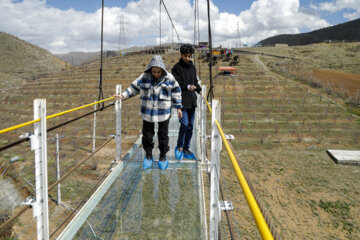 Tourists visiting Iran's largest glass suspension bridge