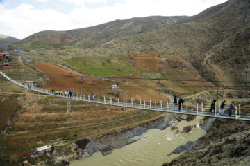 Tourists visiting Iran's largest glass suspension bridge