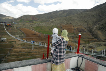 Tourists visiting Iran's largest glass suspension bridge
