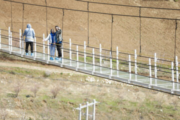 Tourists visiting Iran's largest glass suspension bridge