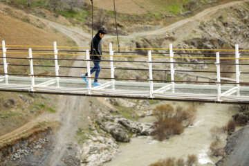 Tourists visiting Iran's largest glass suspension bridge