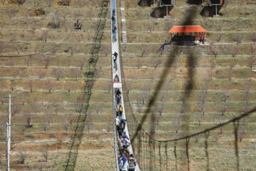 Tourists visiting Iran's largest glass suspension bridge