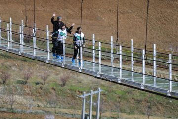 Tourists visiting Iran's largest glass suspension bridge