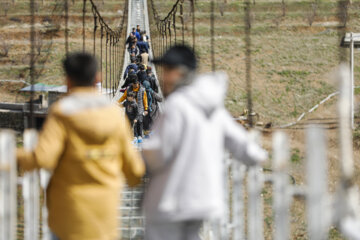 Tourists visiting Iran's largest glass suspension bridge
