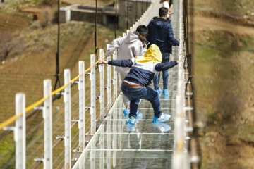 Tourists visiting Iran's largest glass suspension bridge