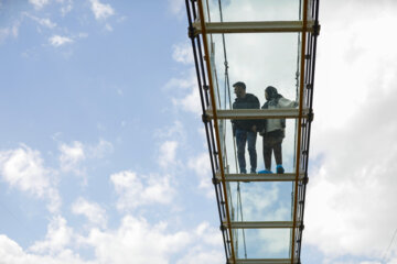 Tourists visiting Iran's largest glass suspension bridge