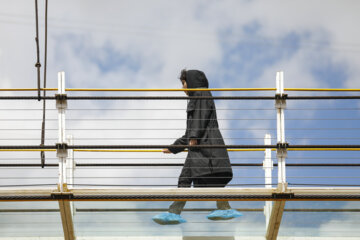 Tourists visiting Iran's largest glass suspension bridge