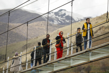 Tourists visiting Iran's largest glass suspension bridge