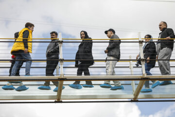 Tourists visiting Iran's largest glass suspension bridge