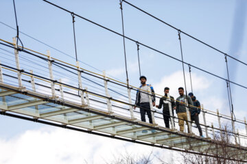 Tourists visiting Iran's largest glass suspension bridge