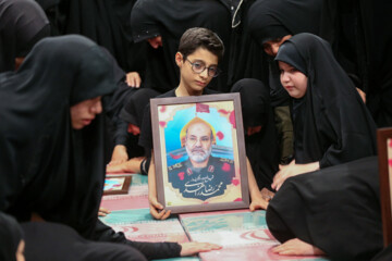 Supreme Leader praying over bodies of seven martyrs