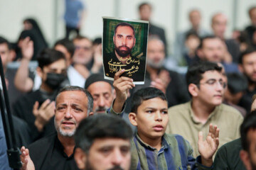 Supreme Leader praying over bodies of seven martyrs