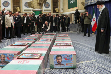 Supreme Leader praying over bodies of seven martyrs