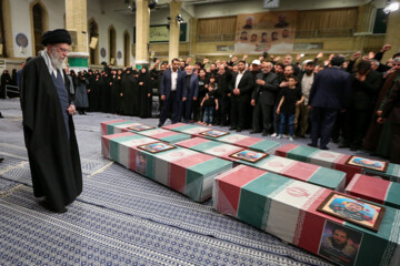 Supreme Leader praying over bodies of seven martyrs