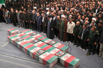 Supreme Leader praying over bodies of seven martyrs