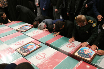 Supreme Leader praying over bodies of seven martyrs