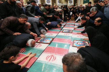 Supreme Leader praying over bodies of seven martyrs