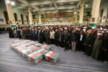 Supreme Leader praying over bodies of seven martyrs
