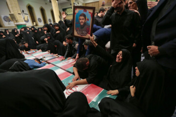 Supreme Leader praying over bodies of seven martyrs