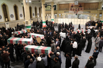 Supreme Leader praying over bodies of seven martyrs