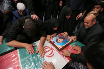 Supreme Leader praying over bodies of seven martyrs