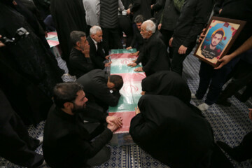 Supreme Leader praying over bodies of seven martyrs