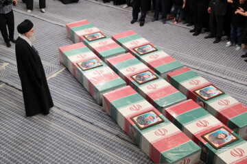 Supreme Leader praying over bodies of seven martyrs