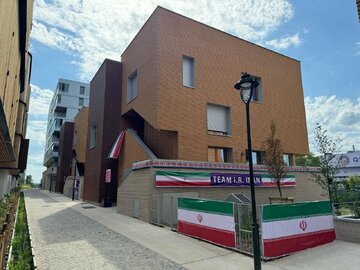 Building of Iranian caravan for Paris Olympics decorated with nat’l flags