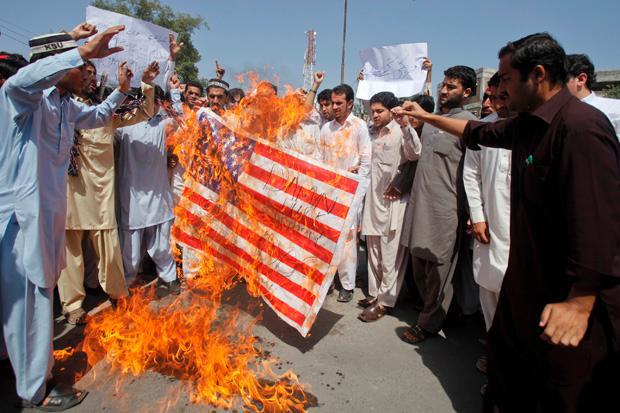 Pakistani angry protestors put US flags on fire Pakistani angry protestors put US flags on fire