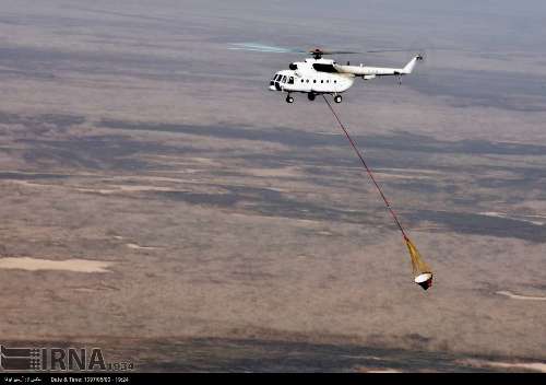 Extinguishing fire in Hoor al-Azim lagoon