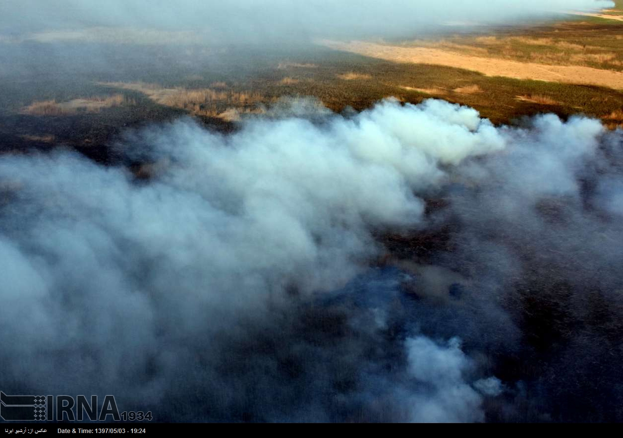 Extinguishing fire in Hoor al-Azim lagoon